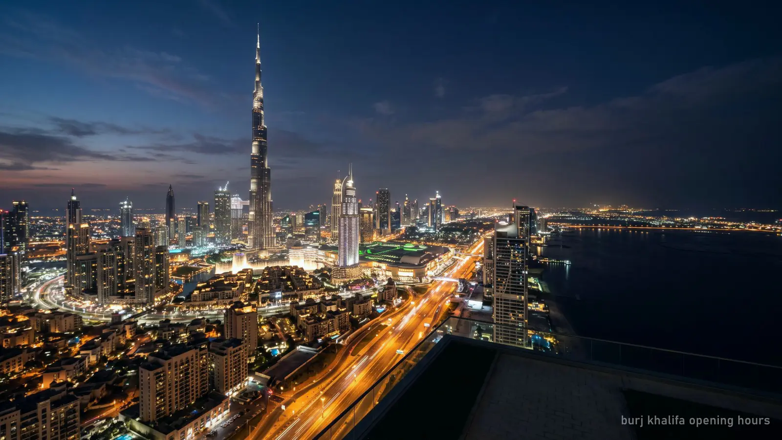 The Burj Khalifa lit at night with the city below, late evening (generated illustration)