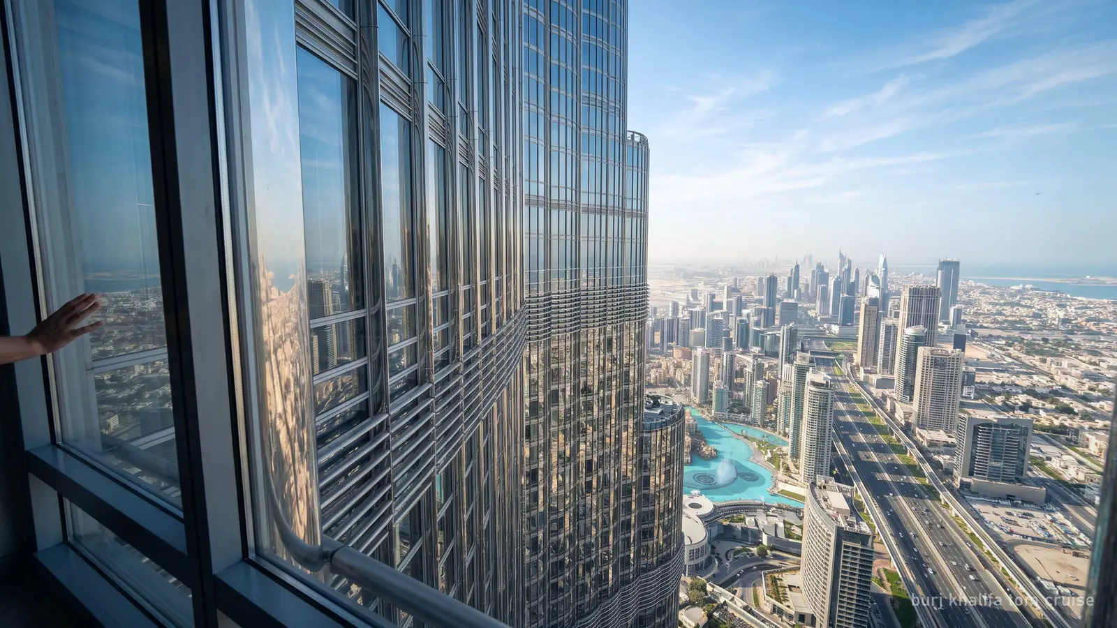 The sheer glass facade of the Burj Khalifa high above the city, looking along the wall from a window (generated illustration)